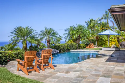 a view of a backyard with furniture and a patio