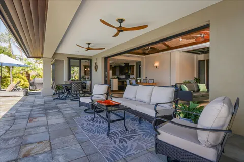 a living room with furniture a rug and a chandelier