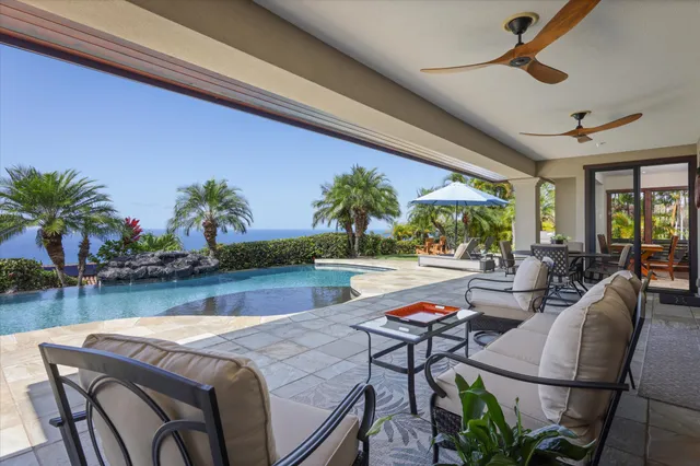 a living room with patio furniture dining table and a potted plant