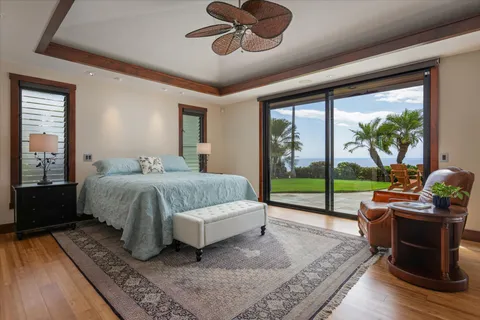 a bedroom with a bed and large windows