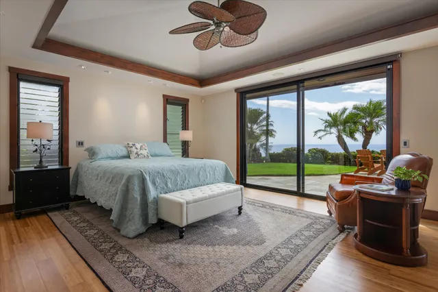 a bedroom with a bed and large windows