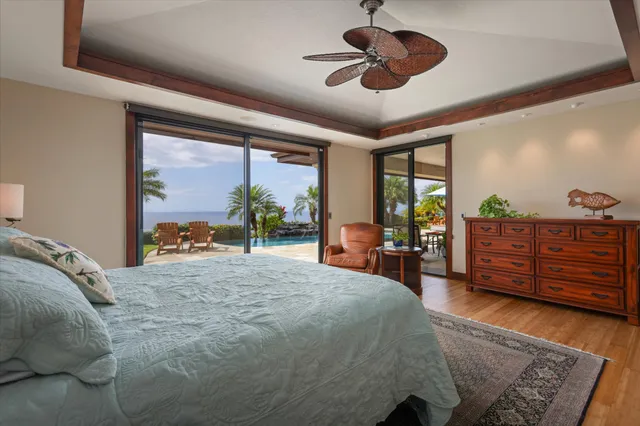 a bed room with a bed dresser and a large window