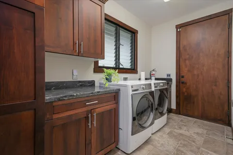 a utility room with sink dryer and washer