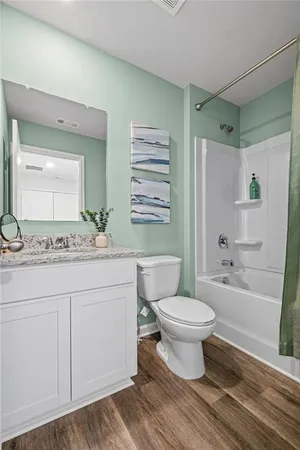 a bathroom with a sink toilet a mirror and shower