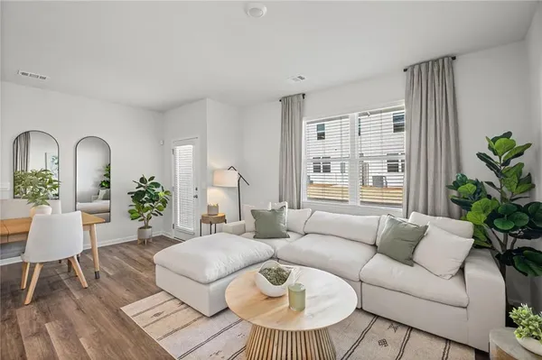 a living room with furniture and a large window