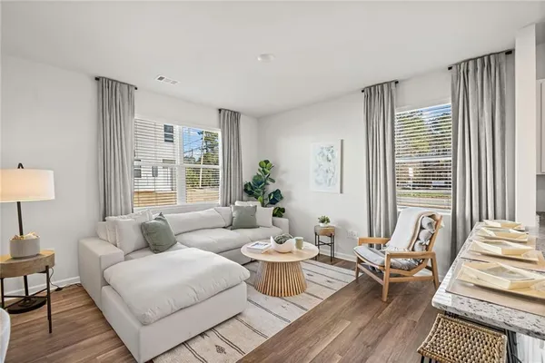 a living room with furniture and a large window