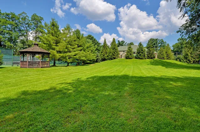 a bathroom with a granite countertop sink a toilet and a mirror