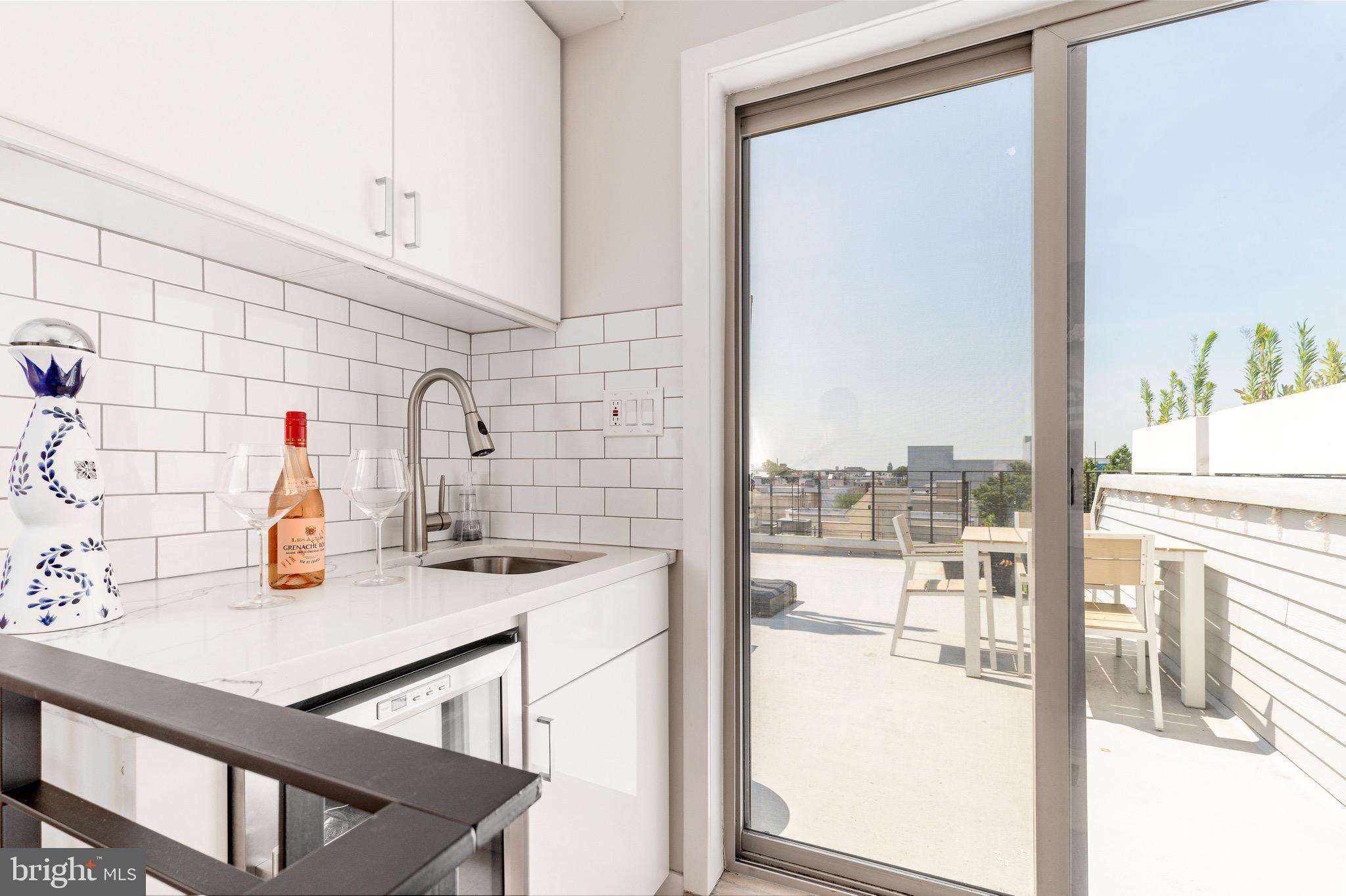1733 Carpenter Street, Unit D Philadelphia, PA 19146 - Photo 30 of 37 a kitchen with a sink and a refrigerator