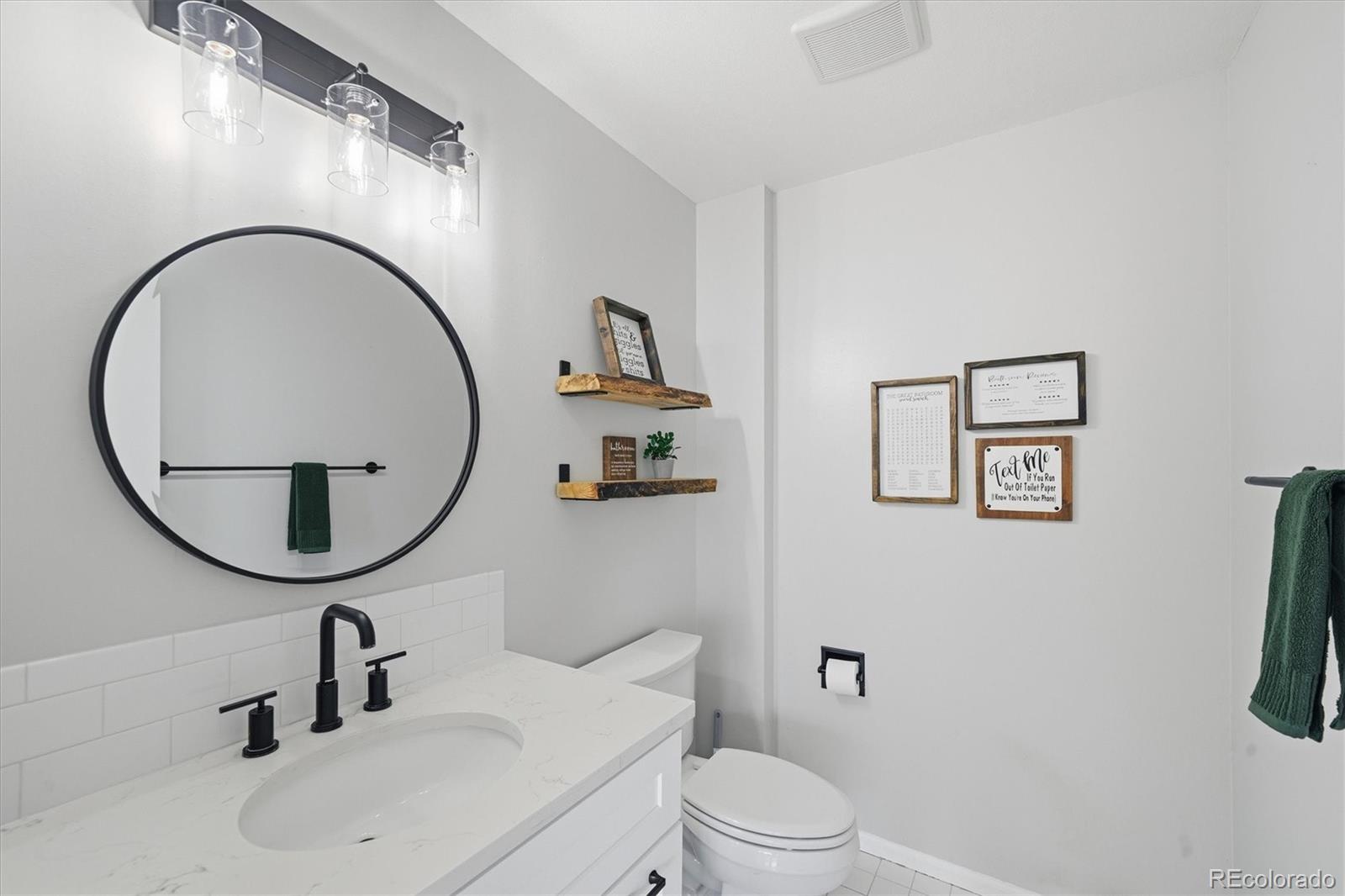 767 Ellis Street Golden, CO 80401 - Photo 18 of 50 a bathroom with a sink a mirror a toilet and a mirror