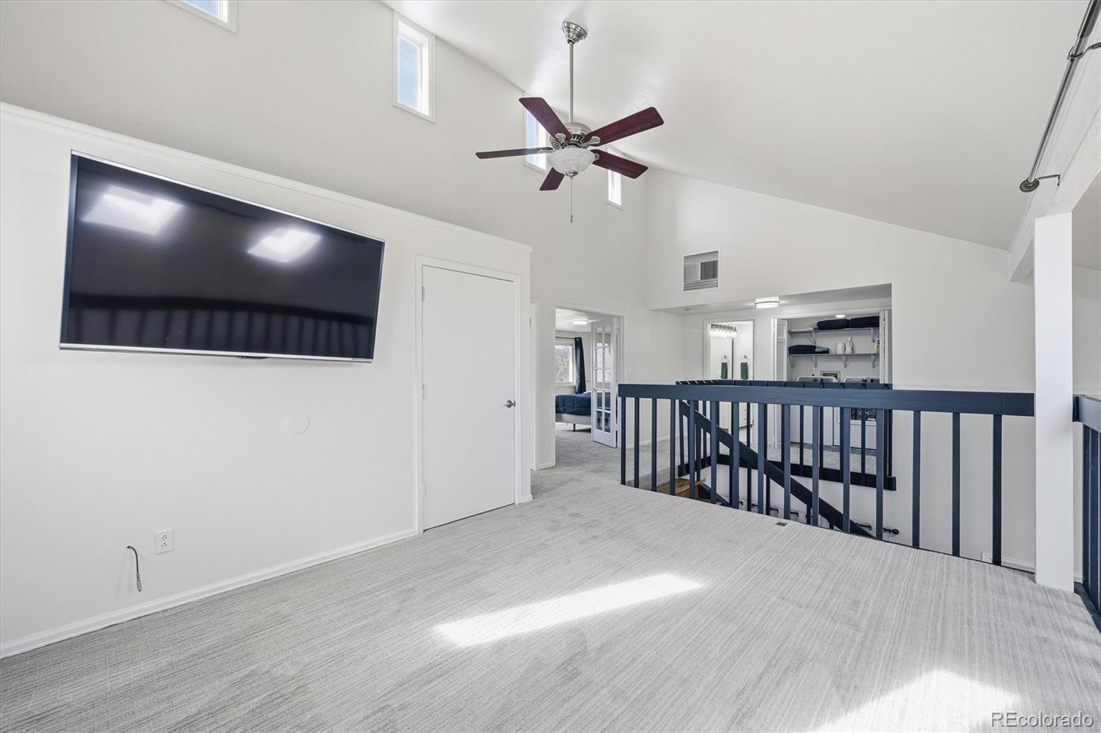 767 Ellis Street Golden, CO 80401 - Photo 19 of 50 a view of a hallway with wooden floor and a ceiling fan