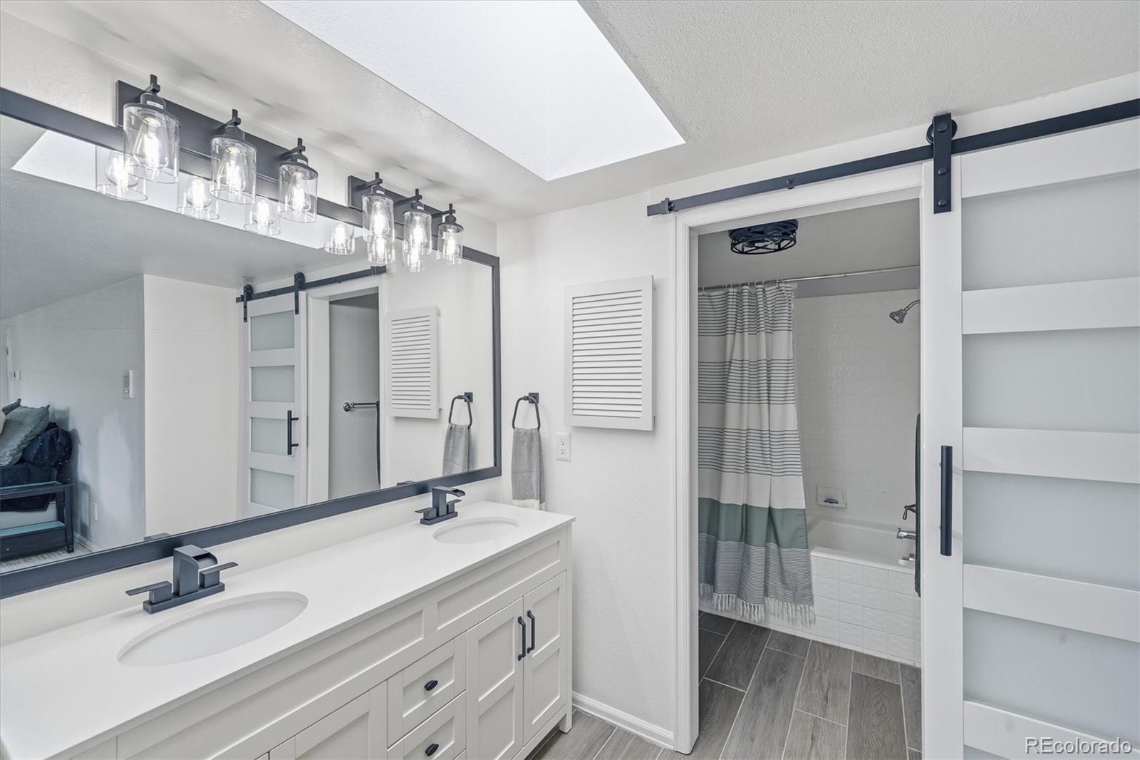 767 Ellis Street Golden, CO 80401 - Photo 26 of 50 a bathroom with a double vanity sink a mirror and shower