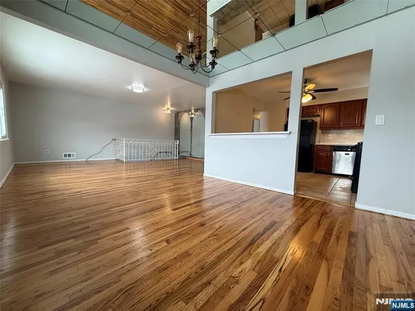 a view of a room with wooden floor