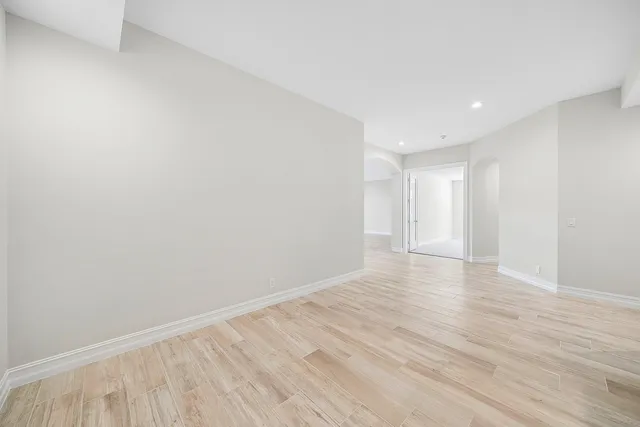 a view of an empty room with wooden floor
