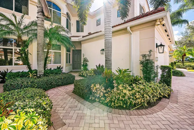 a house with potted plants in front of door