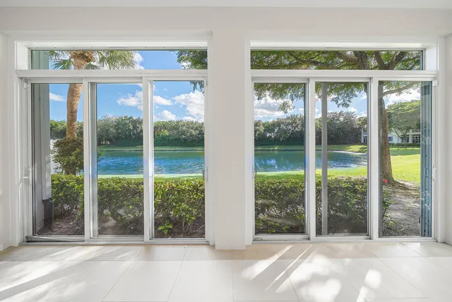 a view of a room with a large window and front door