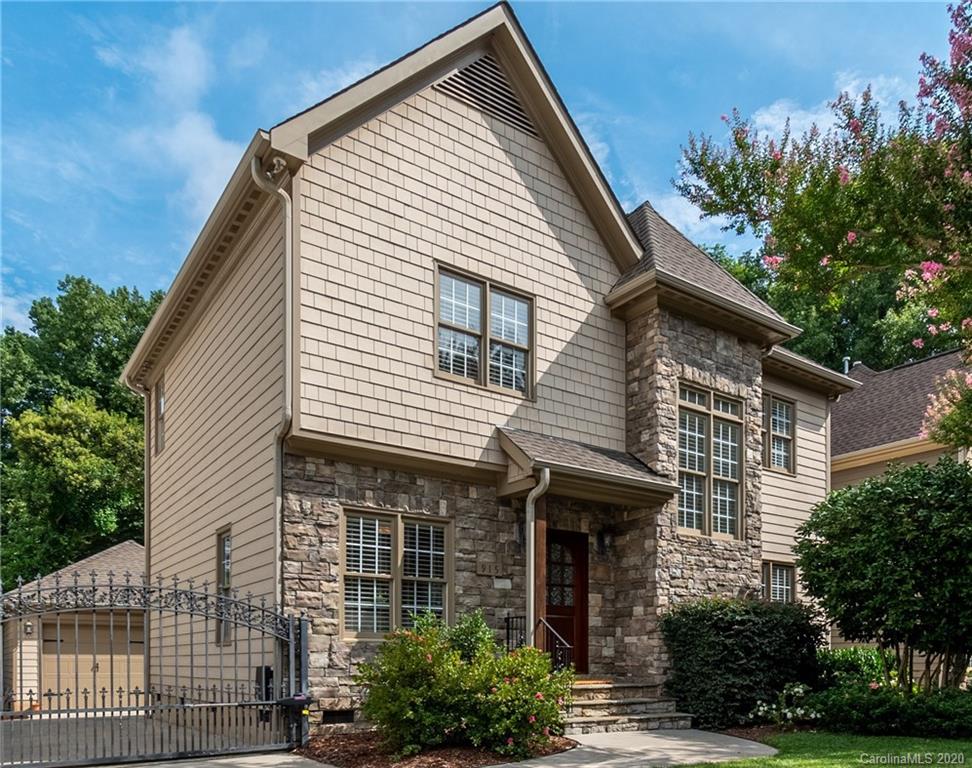 a front view of a house with plants