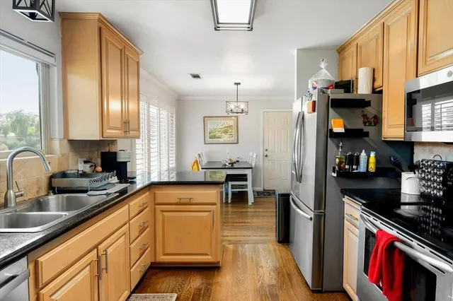 a outdoor space with the couches and dining table with the potted plants