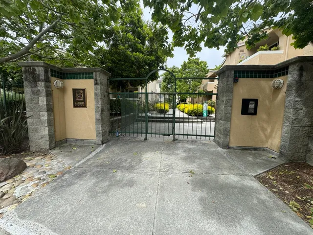 a view of a chairs and table in the back yard
