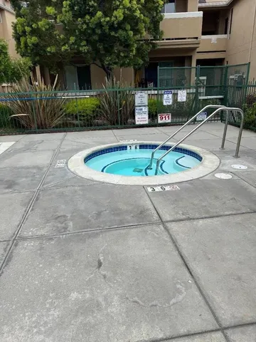 a view of a swimming pool with chairs in patio