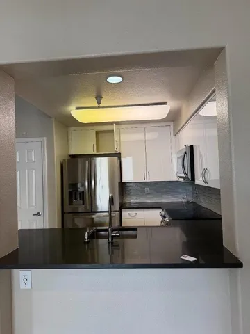 a living room with a stove and a chandelier