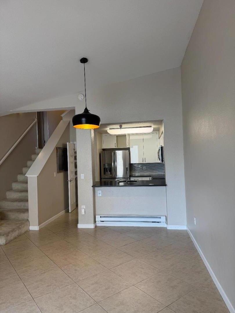 356 Everson Drive Santa Cruz, CA 95060 - Photo 10 of 38 a living room with a stove and a chandelier