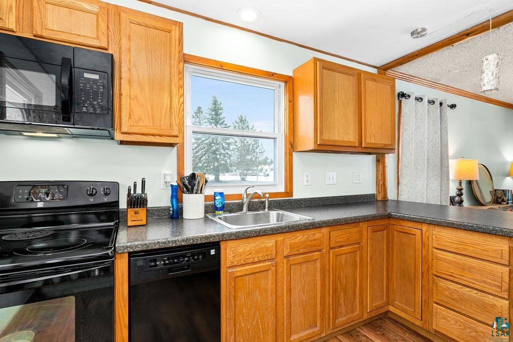 19 Gibson Road Silver Bay, MN 55614 - Photo 5 of 20 Kitchen with sink, hardwood / wood-style flooring, and black appliances
