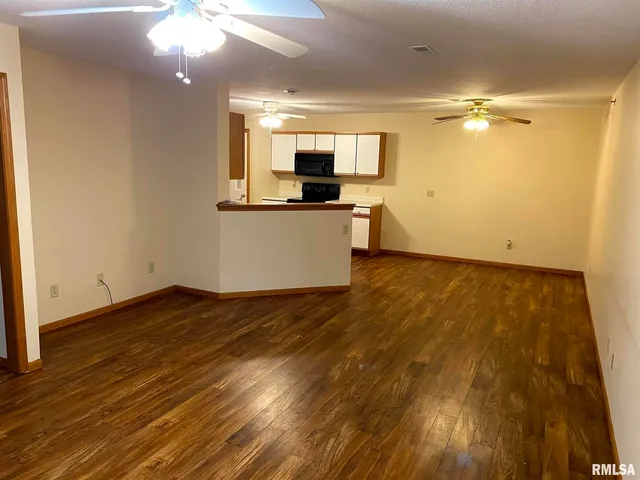 a view of a kitchen with wooden floor and a sink