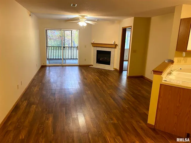 wooden floor in an empty room with a fireplace