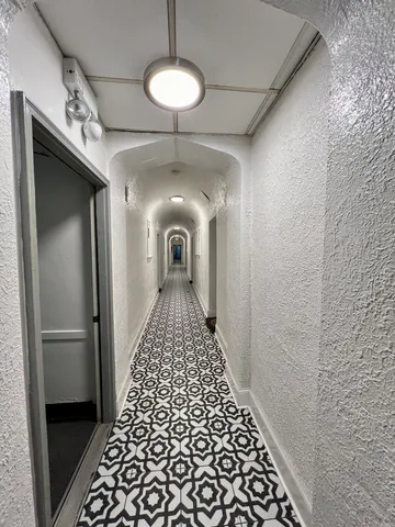 a view of a hallway with a chandelier