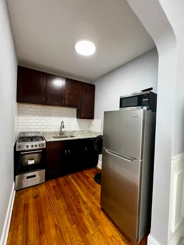 a kitchen with a refrigerator and a stove