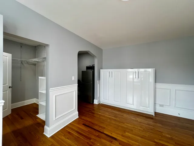 a view of a room with wooden floor