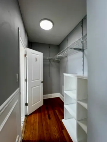 a room with appliances cabinets and furniture