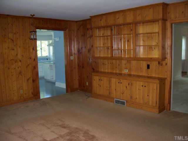 2129 Coley Forest Place Raleigh, NC 27607 - Photo 6 of 10 Den with knotty pine and built-ins