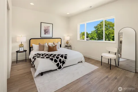 a bedroom with a large bed and a window