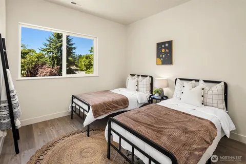 a bedroom with two beds and a window