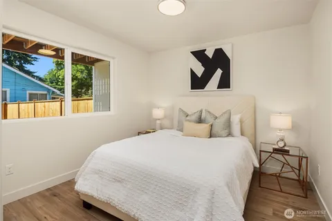 a bedroom with a bed and a painting on the wall