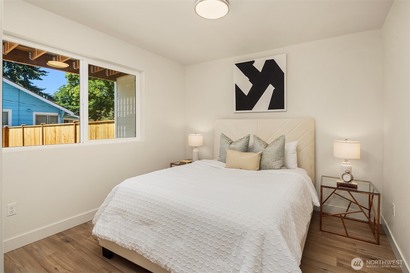 6618 52nd Avenue West University Place, WA 98467 - Photo 23 of 26 a bedroom with a bed and a painting on the wall