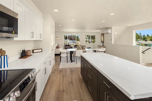 a kitchen with lots of counter top space and wooden floor