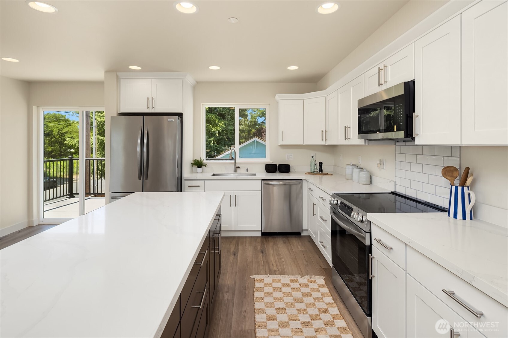 6618 52nd Avenue West University Place, WA 98467 - Photo 5 of 26 a large kitchen with stainless steel appliances granite countertop a stove a sink dishwasher a refrigerator and a oven with wooden floor