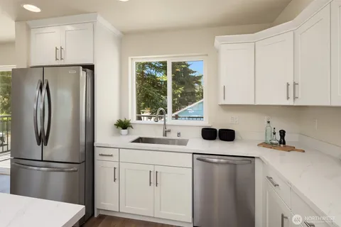 a kitchen with stainless steel appliances a refrigerator sink and cabinets