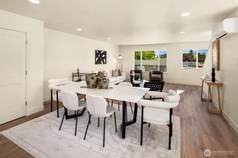 a view of a dining room with furniture window and wooden floor
