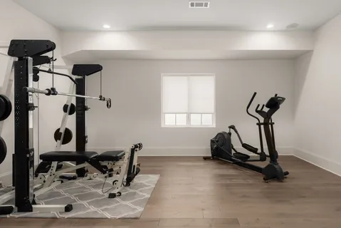 a room with gym equipment and windows
