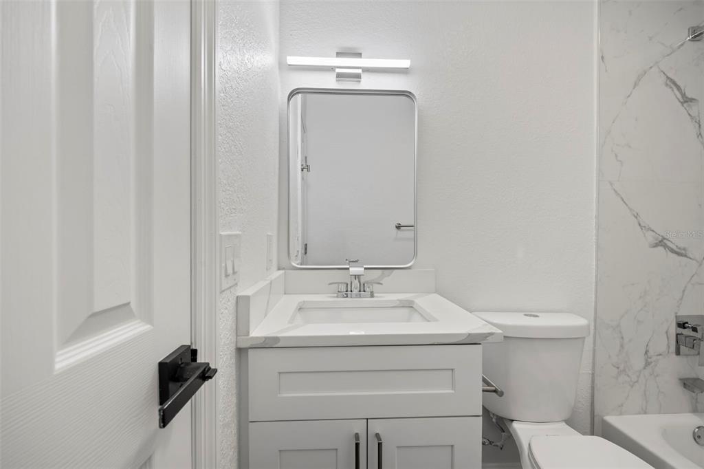 5317 Curry Ford Road, Unit 203 BLDG L Orlando, FL 32812 - Photo 11 of 18 a bathroom with a sink vanity mirror and toilet