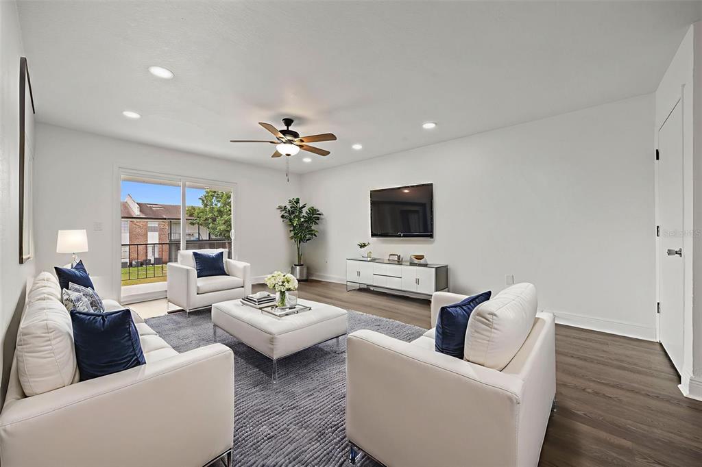 5317 Curry Ford Road, Unit 203 BLDG L Orlando, FL 32812 - Photo 2 of 18 a living room with furniture and a flat screen tv