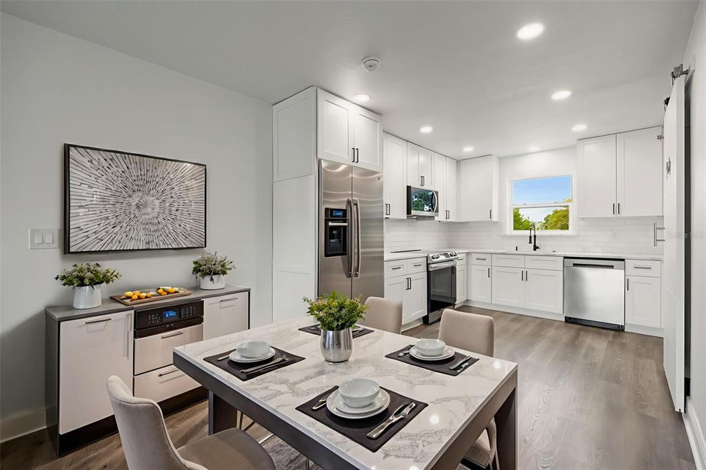 5317 Curry Ford Road, Unit 203 BLDG L Orlando, FL 32812 - Photo 3 of 18 a living room with stainless steel appliances furniture a dining table and chairs