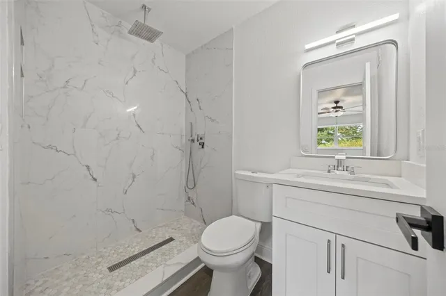 a bathroom with a sink toilet and shower