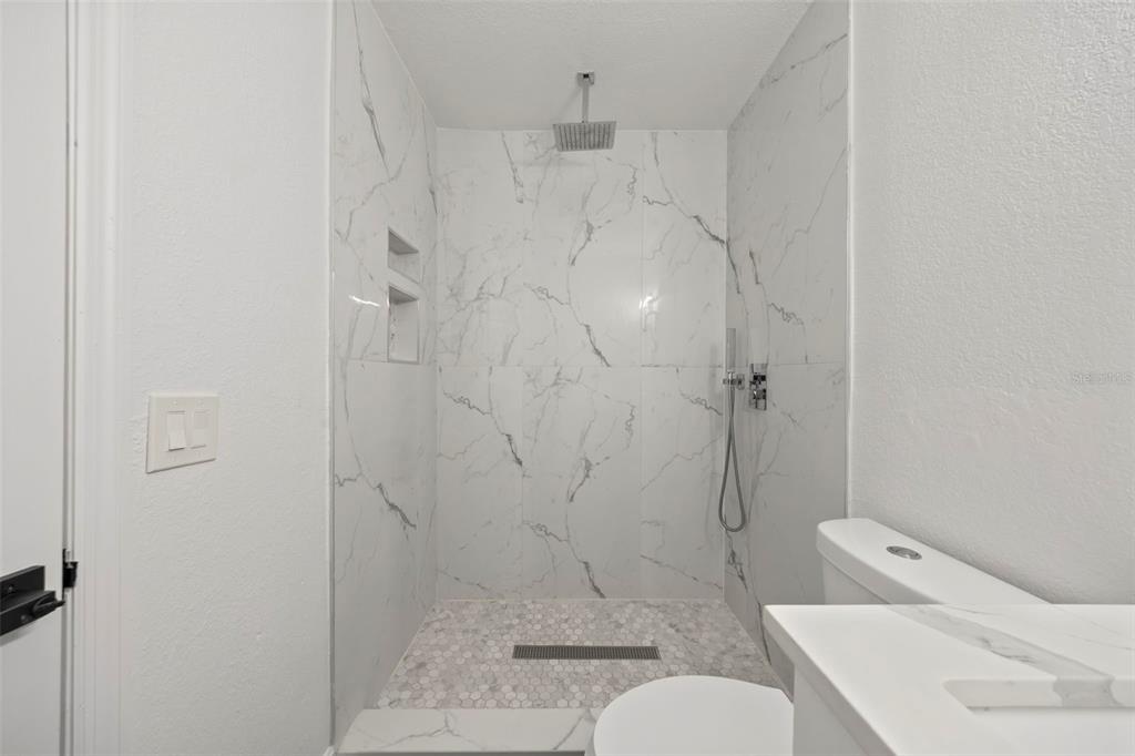 5317 Curry Ford Road, Unit 203 BLDG L Orlando, FL 32812 - Photo 6 of 18 a bathroom with a shower and toilet