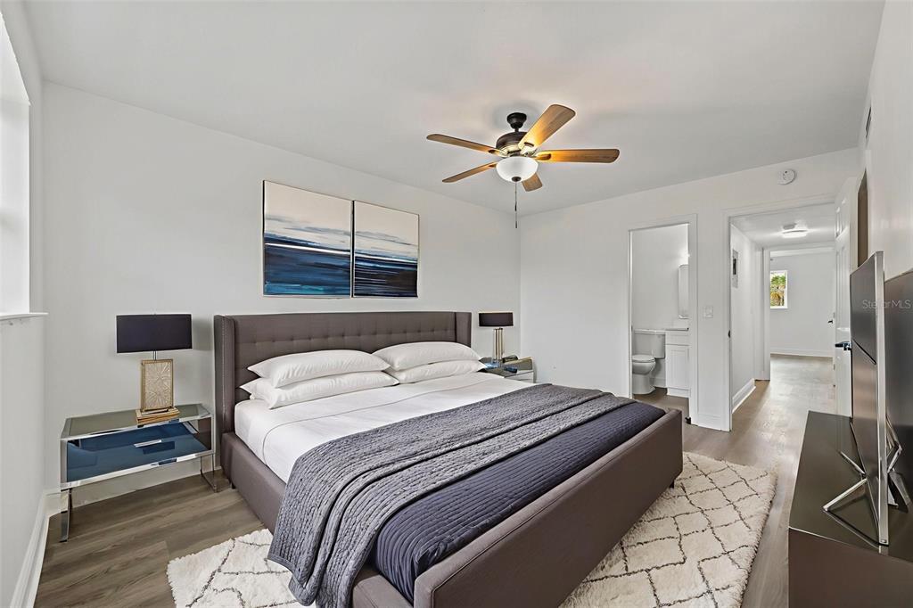 5317 Curry Ford Road, Unit 203 BLDG L Orlando, FL 32812 - Photo 7 of 18 a bedroom with a bed a chandelier and a window