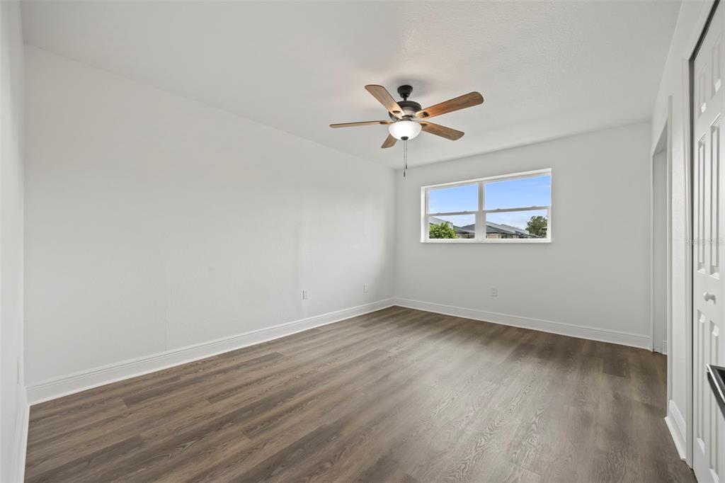 5317 Curry Ford Road, Unit 203 BLDG L Orlando, FL 32812 - Photo 8 of 18 an empty room with wooden floor fan and windows