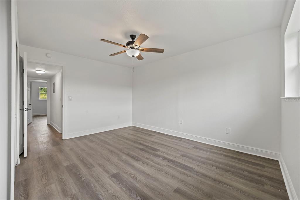 5317 Curry Ford Road, Unit 203 BLDG L Orlando, FL 32812 - Photo 9 of 18 a view of empty room with wooden floor and fan